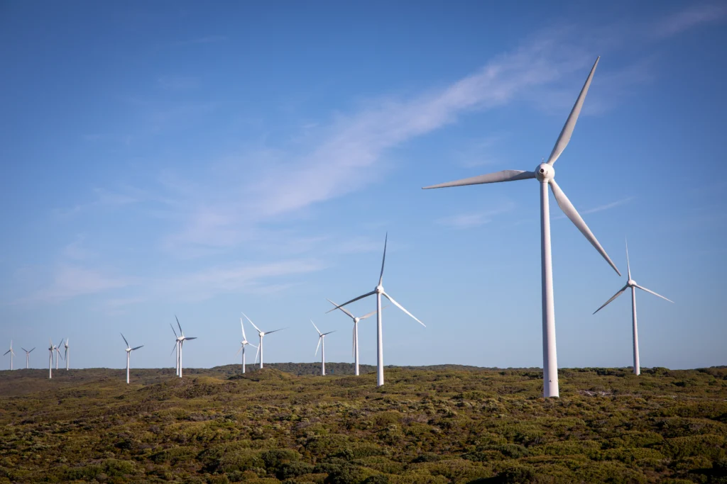 Wind turbines across a remote wind farm site, illustrating the wide areas where field teams may need reliable radio communication.
